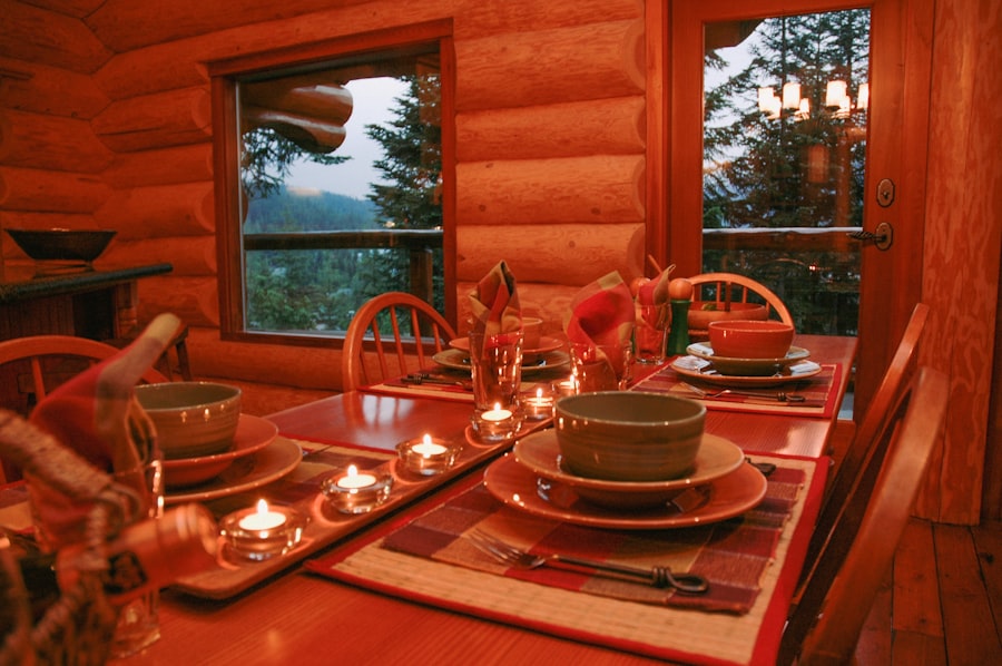 a dining room table set with place settings and candles