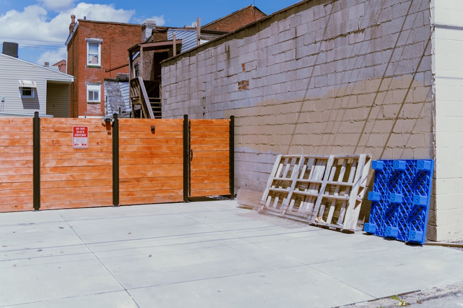 a wooden fence next to a brick building