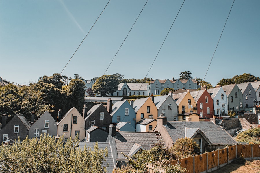 Colorful houses line a hillside under a clear sky.